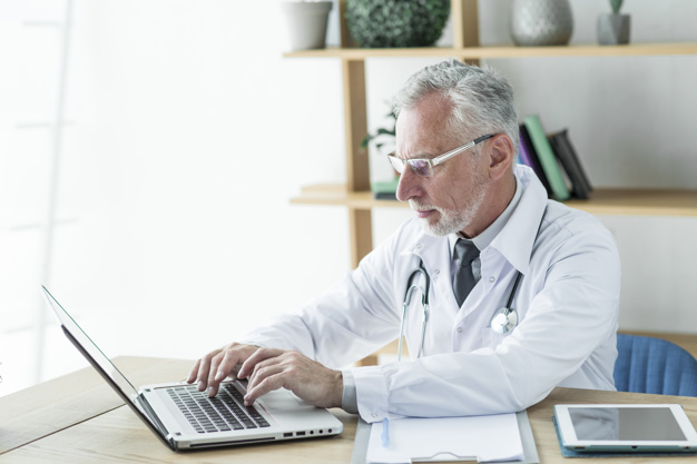 doctor-using-laptop-office
