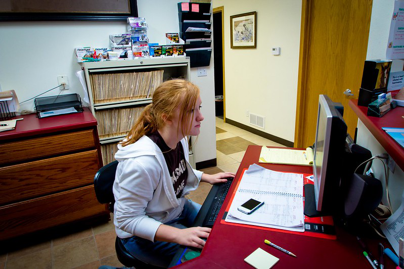 A member of clinic staff maintaining electronic records for a veterinary clinic